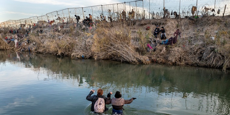 An aerial view of migrants crossing the Rio Grande.