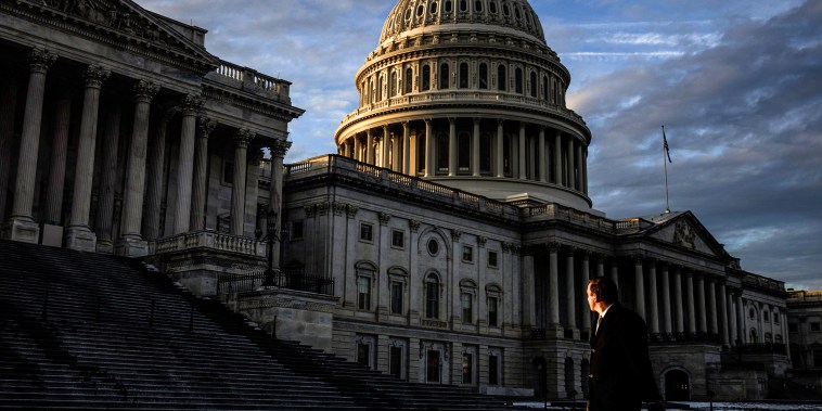 Image: A man walks past the Capitol building on Jan. 23, 2024.