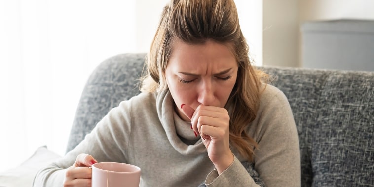 Sick woman coughing.