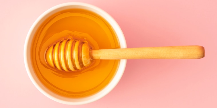 Organic Honey with wooden dipper