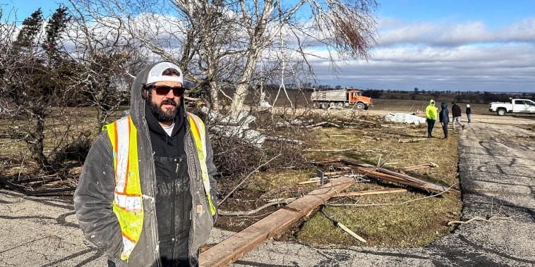 Image: Andy Wagner, 40, surveys the damage on Feb. 9, 2024, outside his parents' home in the Town of Porter, Wis.,
