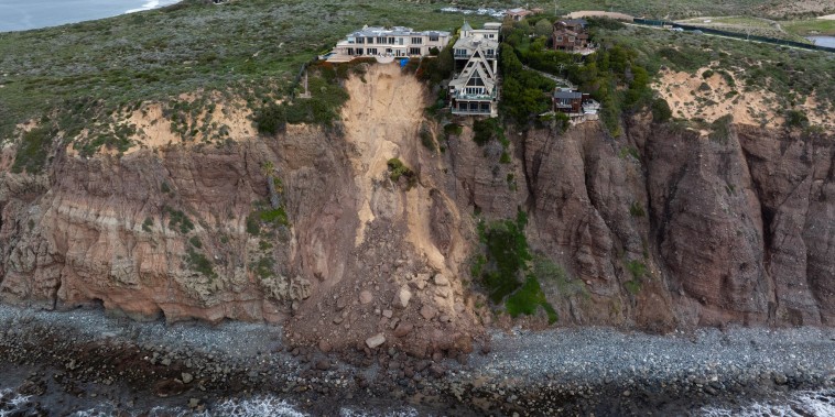 Aerial view of homes along Scenic Drive standing on the edge of a cliff