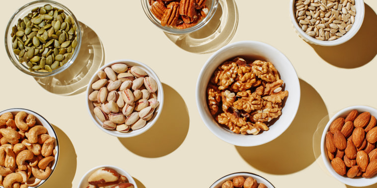 Pattern of various nuts on a background. Includes: pecan, brazil nut, walnut, almonds, hazelnuts, pistachios, cashews.