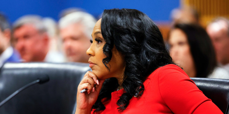 Fani Willis listens during a hearing