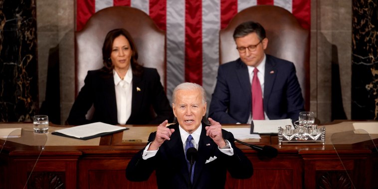 President Biden delivers his State Of The Union address with Kamala Harris and Mike Johnson seated behind him.