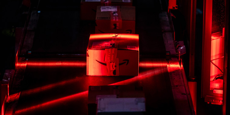 Packages move along a conveyor at an Amazon fulfillment center in Robbinsville, N.J.,