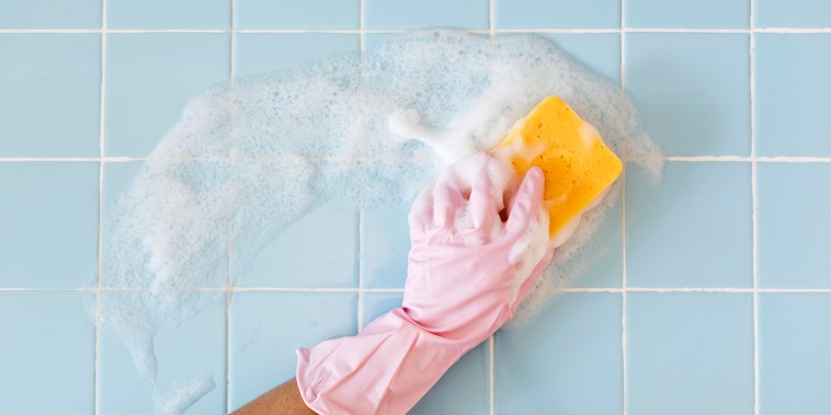 Hand in pink glove with sponge washing