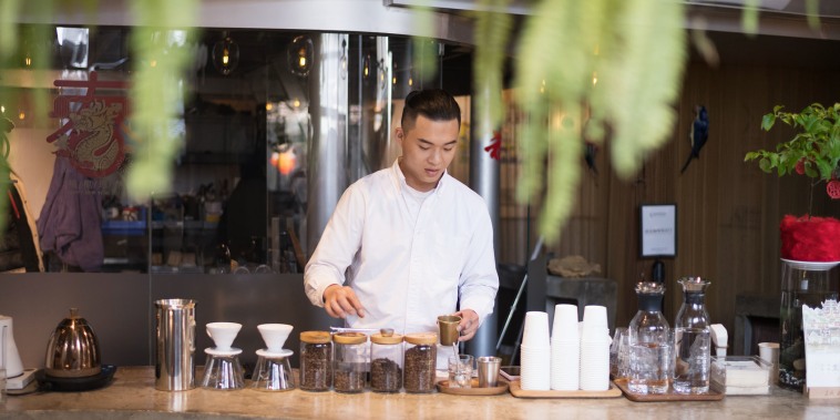 A barista prepares drinks at a coffee shop in Beijing on March 6th, 2024.