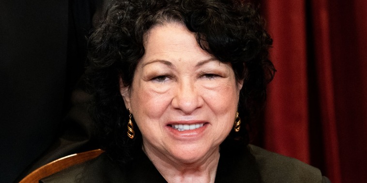 Justice Sonia Sotomayor sits during a group photo of the Justices at the Supreme Court