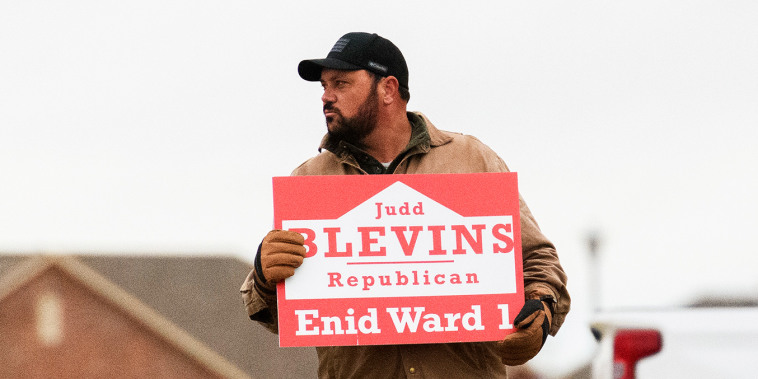 Judd Blevins holds a campaign sign in Enid.