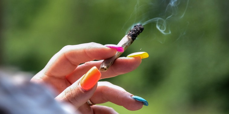 A woman smokes a joint