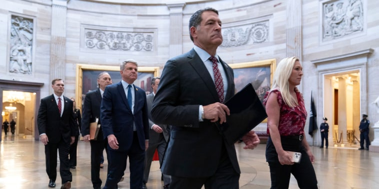 House Impeachment Managers from left, Michael Guest, Andy Biggs, Michael McCaul, Mark Green, and Marjorie Taylor Greene, walk cross the Capitol Rotunda to deliver Homeland Security Secretary Alejandro Mayorkas' Impeachment Articles at the Capitol