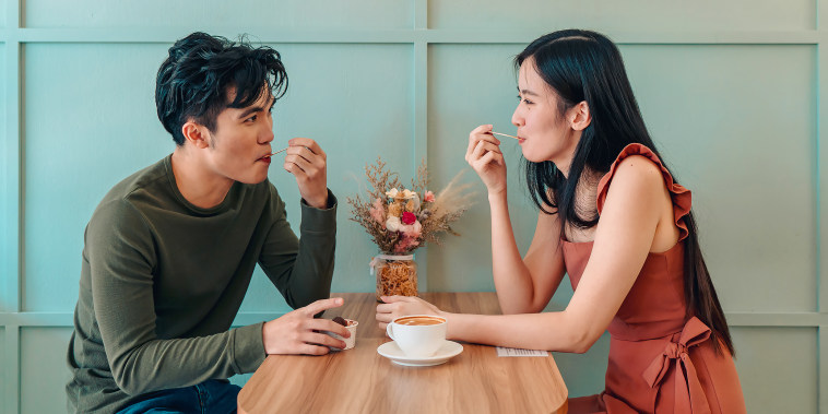 Young couple locking eyes in a cafe