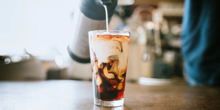 Barista Pours Milk Into Cold Brew Coffee