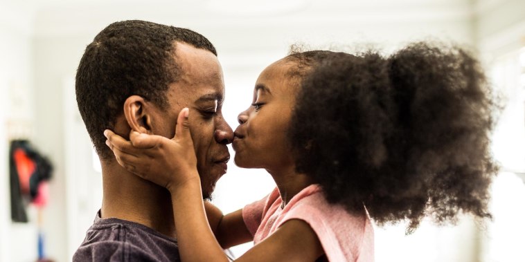 daughter kissing father on the nose