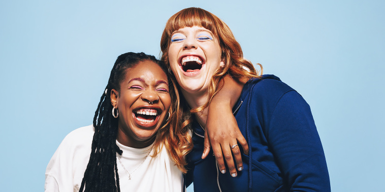 Two interracial best friends laughing together