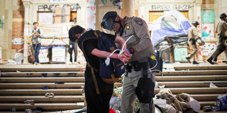 A California Highway Patrol officer detains a protestor.