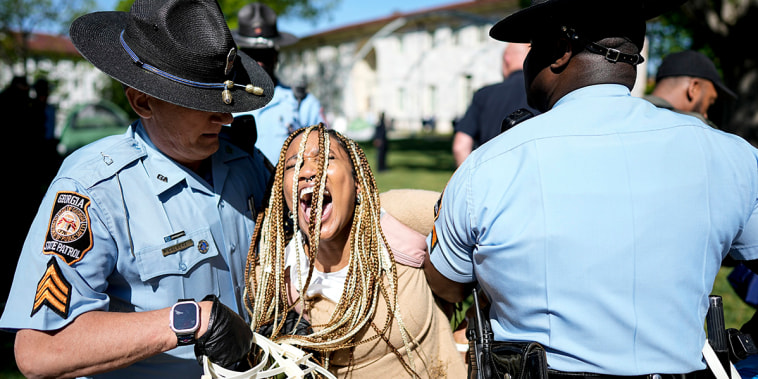 Georgia State Patrol officers detain a demonstrator on the campus of Emory University 