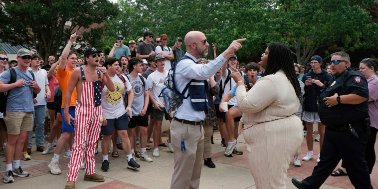 A neutral campus organizer, center, tries to direct a pro-Palestinian demonstrator away from a group of counter-protesters.