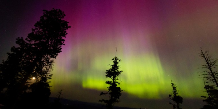 Northern lights in the sky, magenta and green