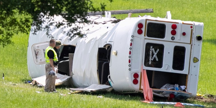 Authorities work at the scene of a deadly crash
