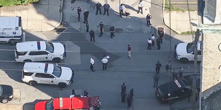 Aerial view of the crime scene with police officer and police cars on the street