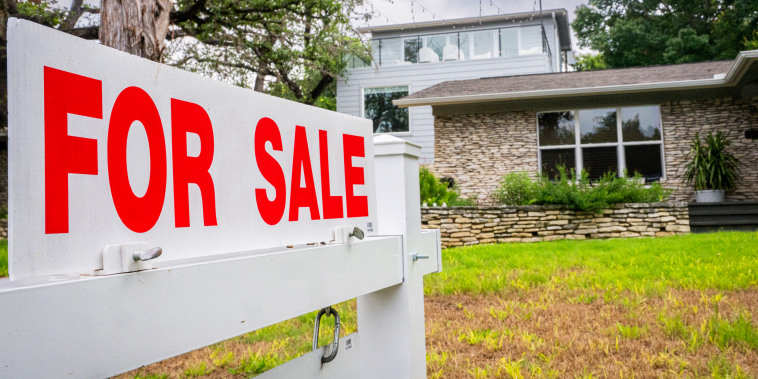 A 'for sale' sign outside a home.