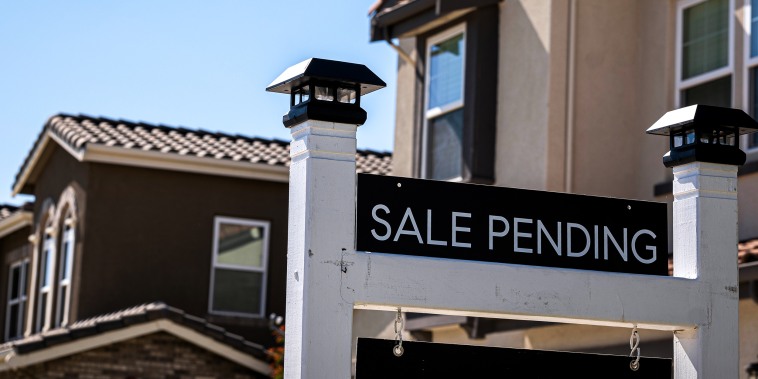 A "Sale Pending" sign outside a house.