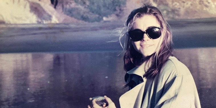 Old photo of Ruth outside by a lake 