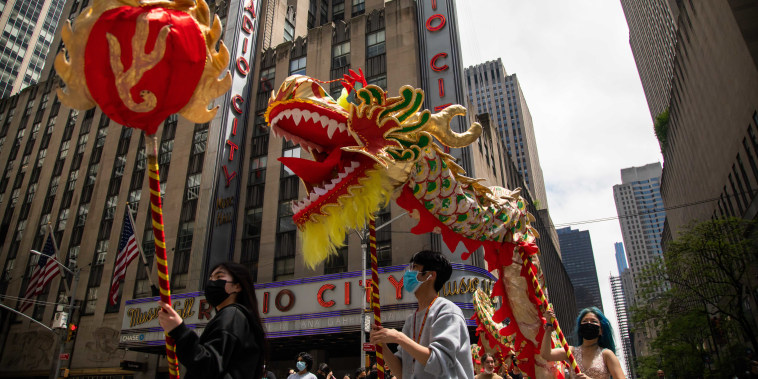 Dragon dancer in front of Radio City Music Hall in  AAPI Cultural and Heritage Parade.