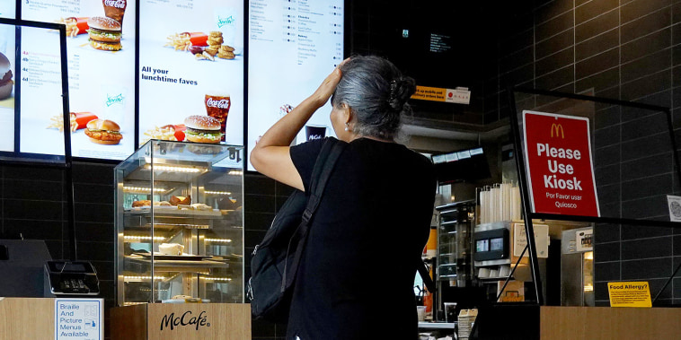 A customer waits to order food at a  McDonalds fast food restaurant on July 26, 2022 in Miami, Florida. 