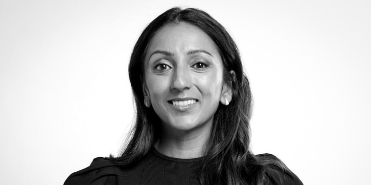 Amy Jain smiles, black and white photo