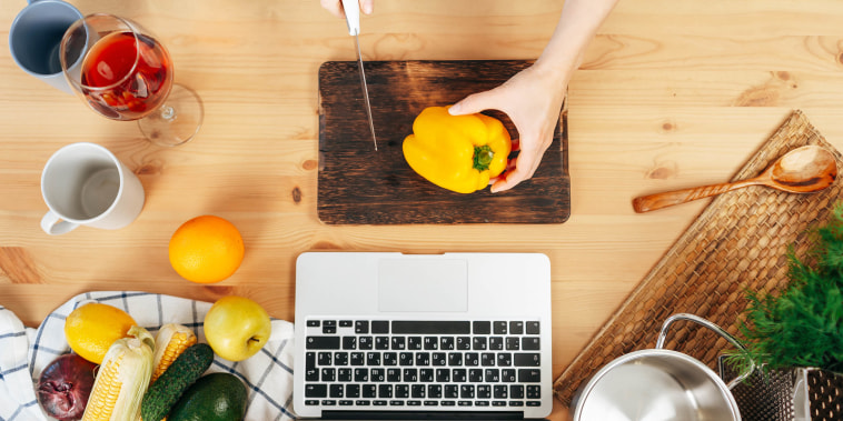 Woman cooking with computer