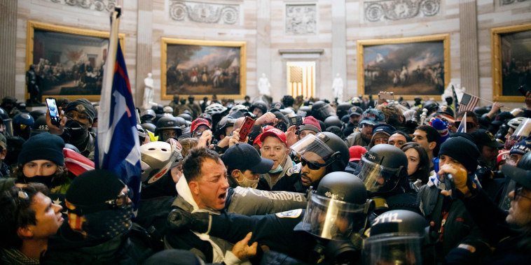 Rioters and police inside the Capitol