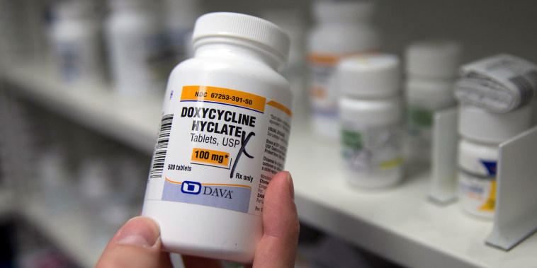 A pharmacist holds a bottle of the antibiotic doxycycline hyclate in Sacramento, Calif.