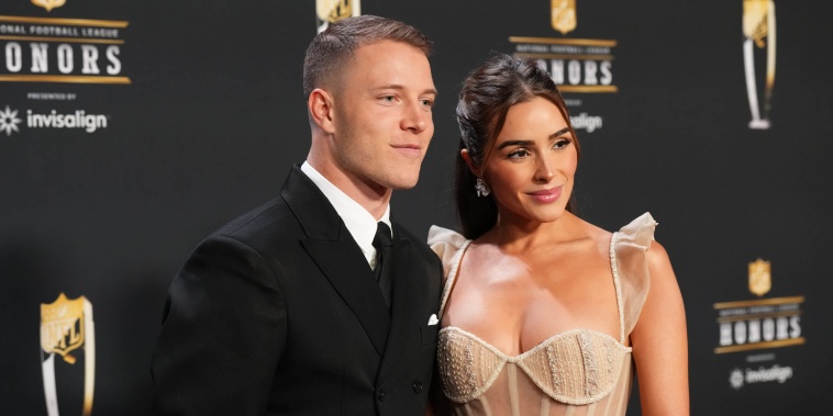 Christian McCaffrey and Olivia Culpo pose for a photo on the red carpet during NFL Honors at the Symphony Hall