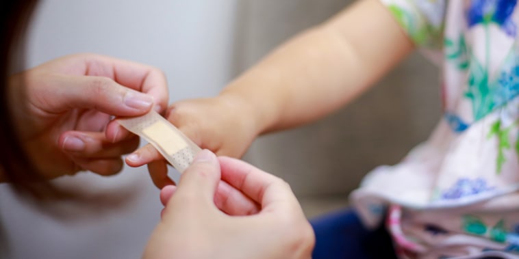 Girl getting a band aid.