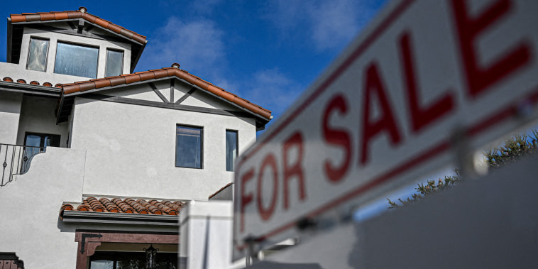 A for sale sign is displayed outside of a home.