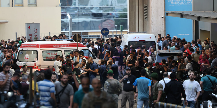 People surround ambulances