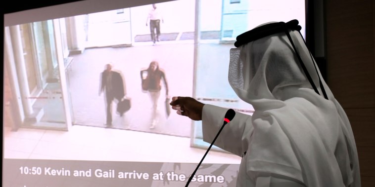 A presenter points to video footage showing two of the 11 suspects involved in the recent killing of a senior Hamas military commander in Dubai