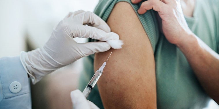 Close up of woman getting flu vaccine.