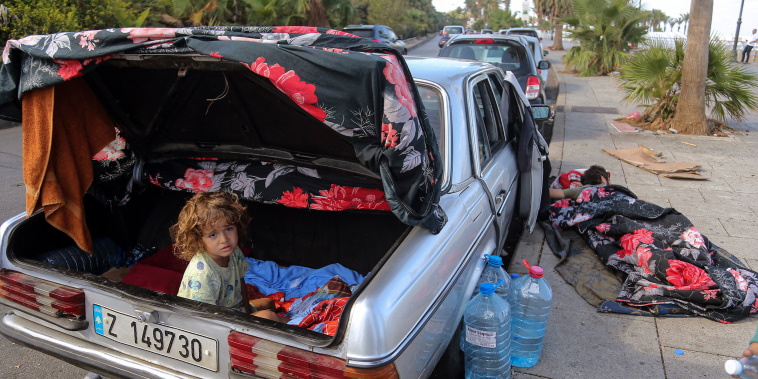 The Abdallah family consisting of four members are using the car as they makeshift home after fleeing Beirut southern suburb last week. 