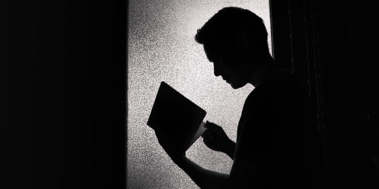 Young man reading book silhouette.