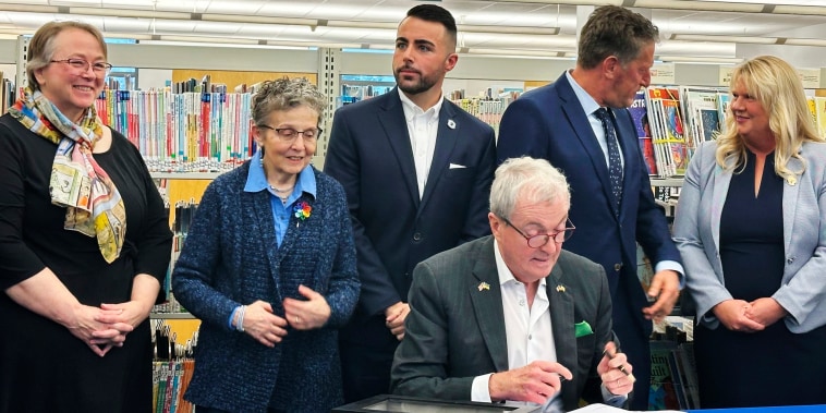 New Jersey Gov. Phil Murphy signs legislation aimed at barring public libraries and schools from banning books on Monday, Dec. 9, 2024, at the Princeton Public Library.