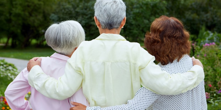Three older women embracing