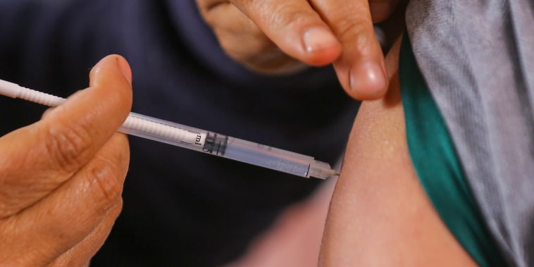 A person gets a vaccine.