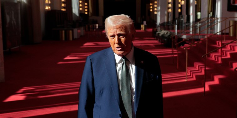 President Donald Trump talks to reporters