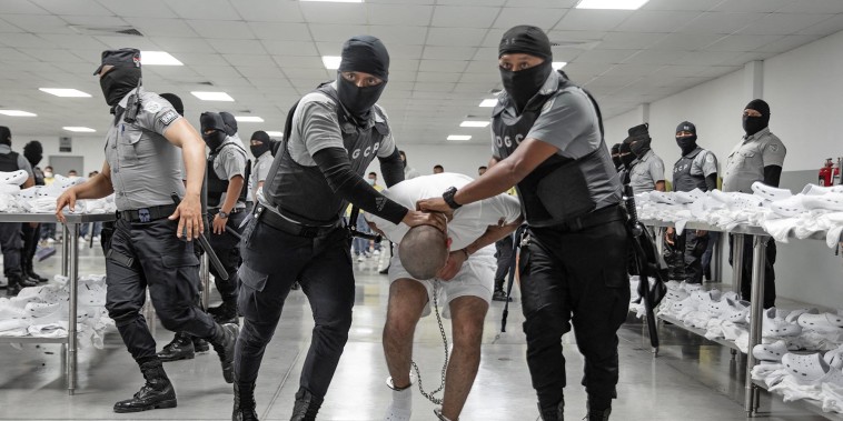 A shackled alleged member of the Venezuelan criminal organization Tren de Aragua deported from the U.S. upon arrival in Tecoluca, El Salvador.