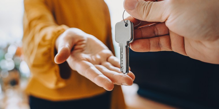 Close-up shot of hands exchanging keys
