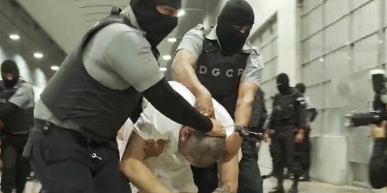 A man identified by Jennifer Vasquez Sura as her husband, Kilmar Abrego Garcia, is led by guards through the Terrorism Confinement Center in Tecoluca, El Salvador. 